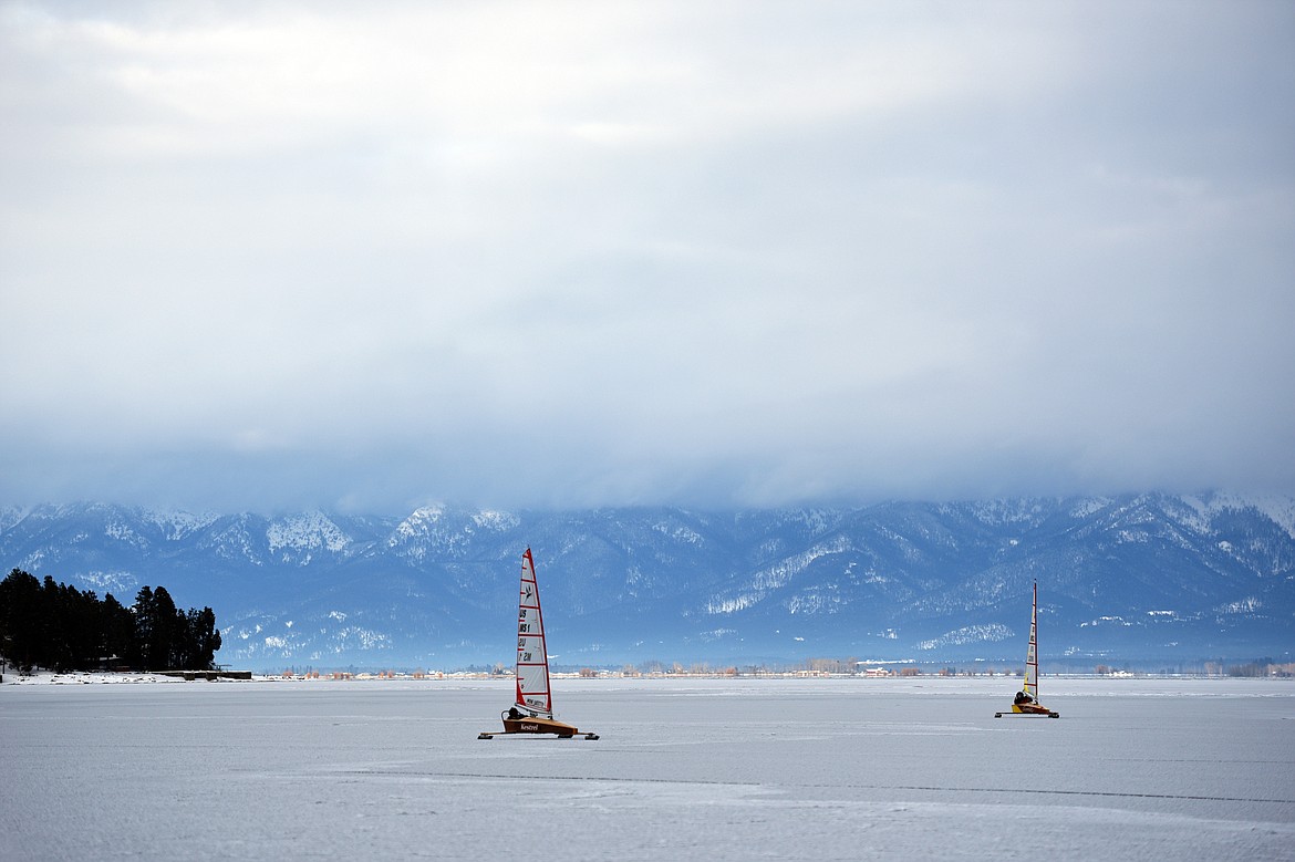 John Eisenlohr, left, and Dave Farmer sail across the frozen surface of Flathead Lake in Lakeside on Feb. 23. (Casey Kreider/Daily Inter Lake)