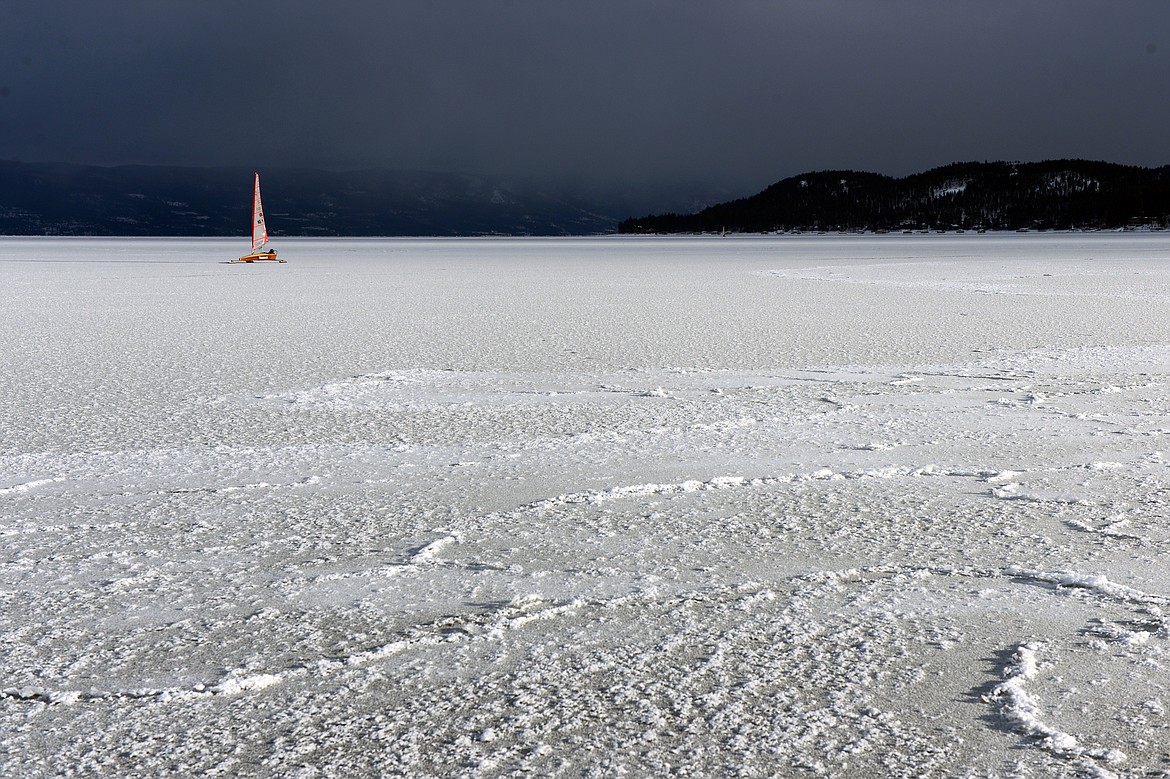 John Eisenlohr of Lakeside sails across the frozen surface of Flathead Lake in Lakeside on Feb. 23. (Casey Kreider/Daily Inter Lake)