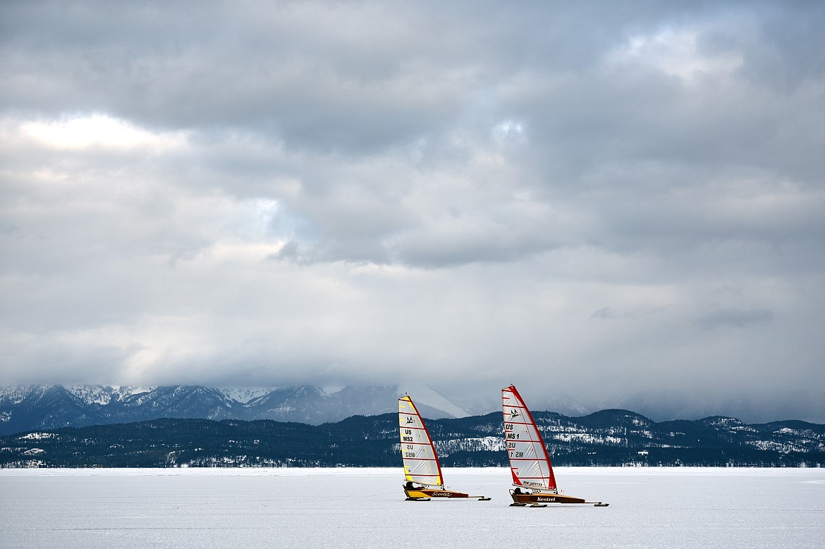 Dave Farmer, left, and John Eisenlohr sail across the frozen surface of Flathead Lake on Feb. 23.