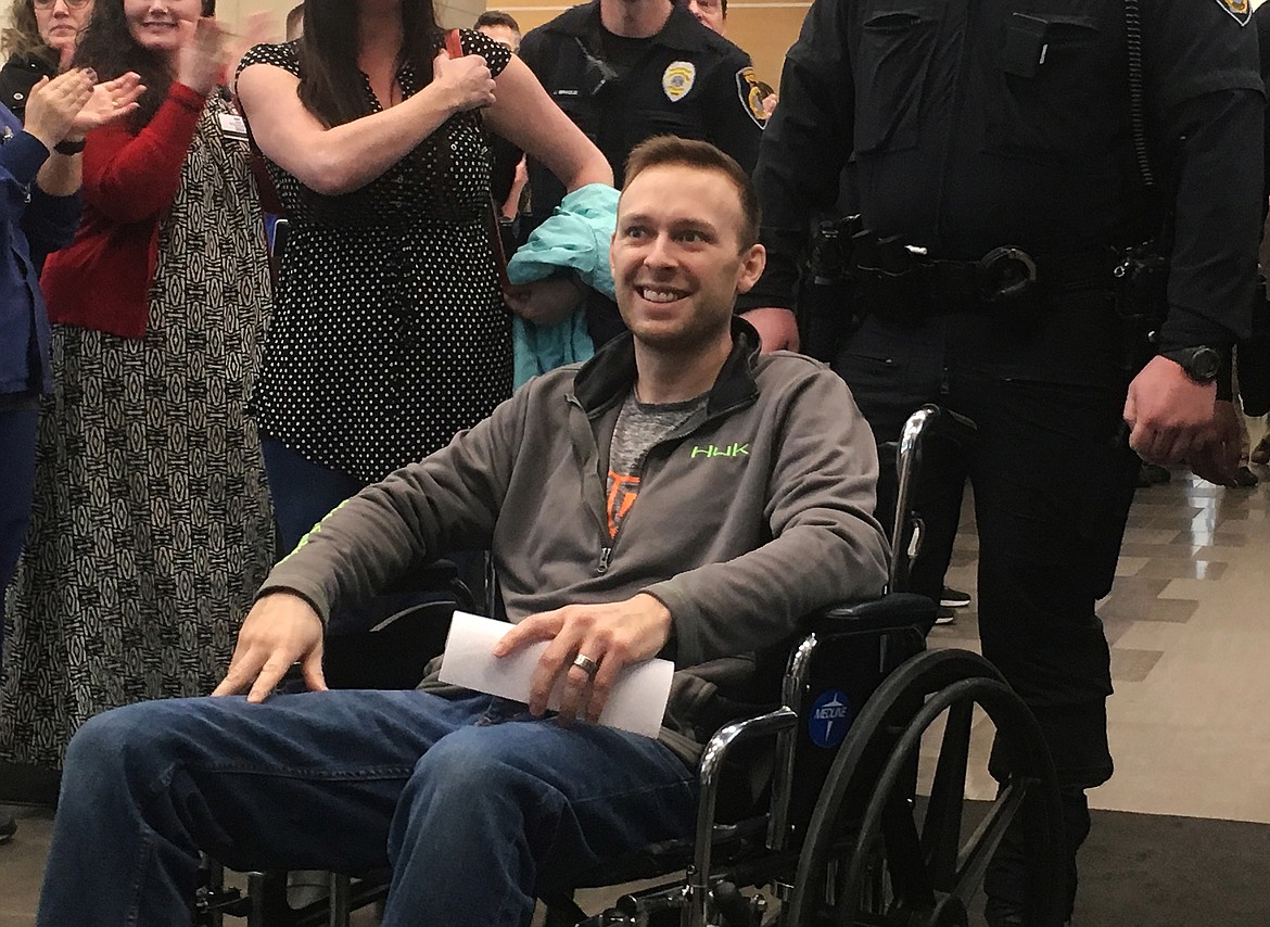 Coeur d&#146;Alene Police officer Charles Hatley is escorted out of Kootenai Health Friday morning. Hatley was shot in the abdomen after exchanging gunfire with Curtis Ware after a traffic stop Tuesday night in Coeur d&#146;Alene. (LOREN BENOIT/Press)