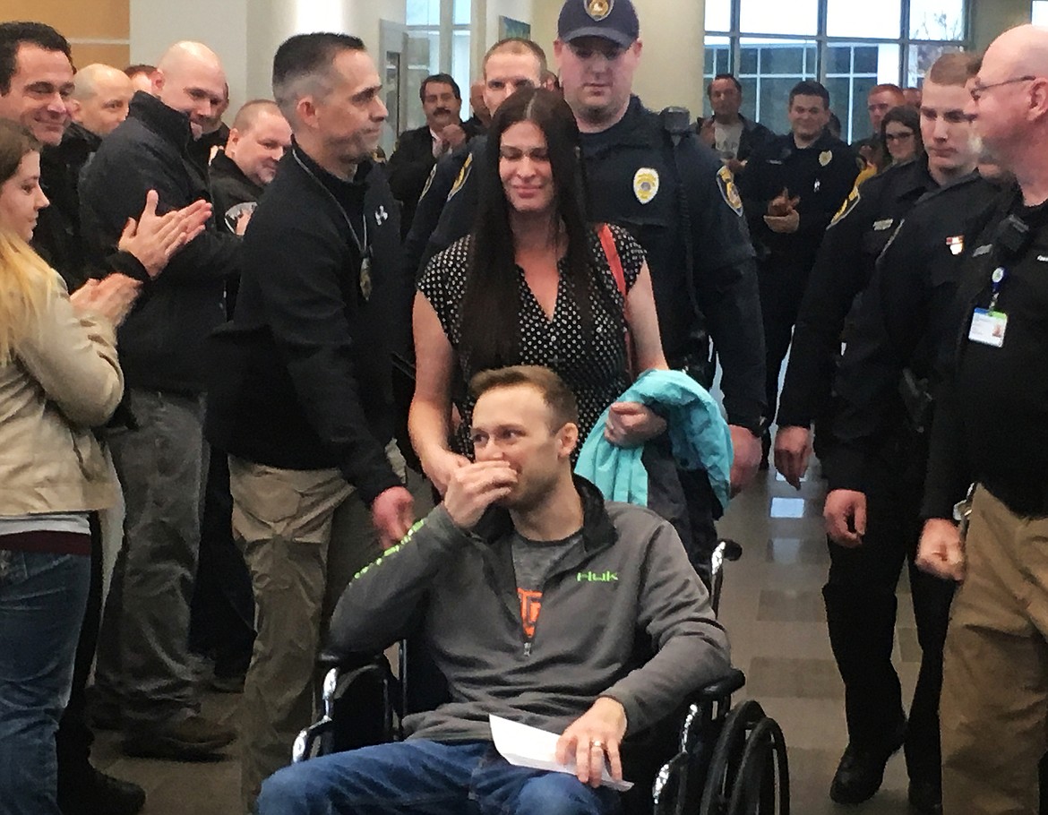 Fellow Coeur d&#146;Alene Police officers show their support as officer Charles Hatley is escorted out of Kootenai Health Friday morning. (LOREN BENOIT/Press)