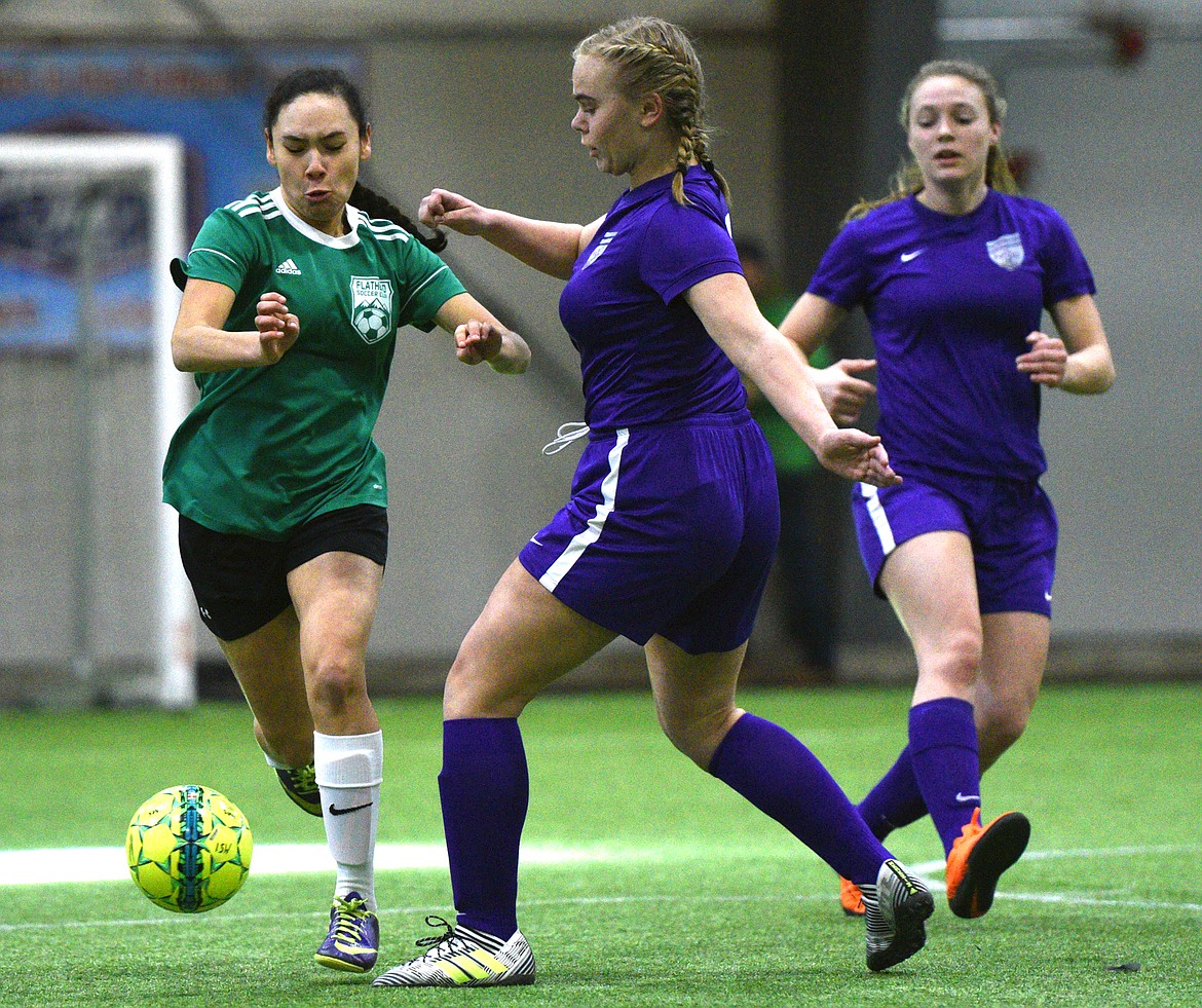 FVU Flathead Force's Ady Powell dribbles upfield against NSC Purple 00's Josephine Brown during the Montana Indoor Soccer Championships at the Flathead County Fairgrounds on Saturday. (Casey Kreider/Daily Inter Lake)