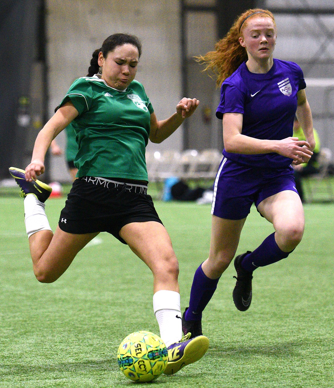 FVU Flathead Force's Gabby Dixon looks to shoot against NSC Purple 00 defender Skyleigh Thompson during the Montana Indoor Soccer Championships at the Flathead County Fairgrounds on Saturday. (Casey Kreider/Daily Inter Lake)