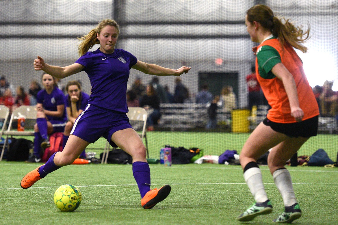 NSC Purple 00's Shayenn Thompson gets a shot on goal against FVU Flathead Force keeper Jascah Vann during the Montana Indoor Soccer Championships at the Flathead County Fairgrounds on Saturday. (Casey Kreider/Daily Inter Lake)