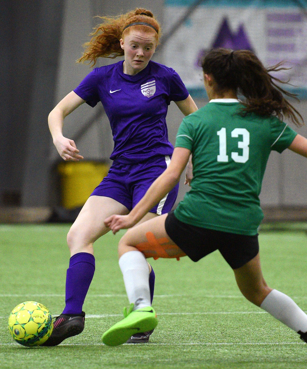 NSC Purple 00's Skyleigh Thompson dribbles upfield against FVU Flathead Force during the Montana Indoor Soccer Championships at the Flathead County Fairgrounds on Saturday. (Casey Kreider/Daily Inter Lake)