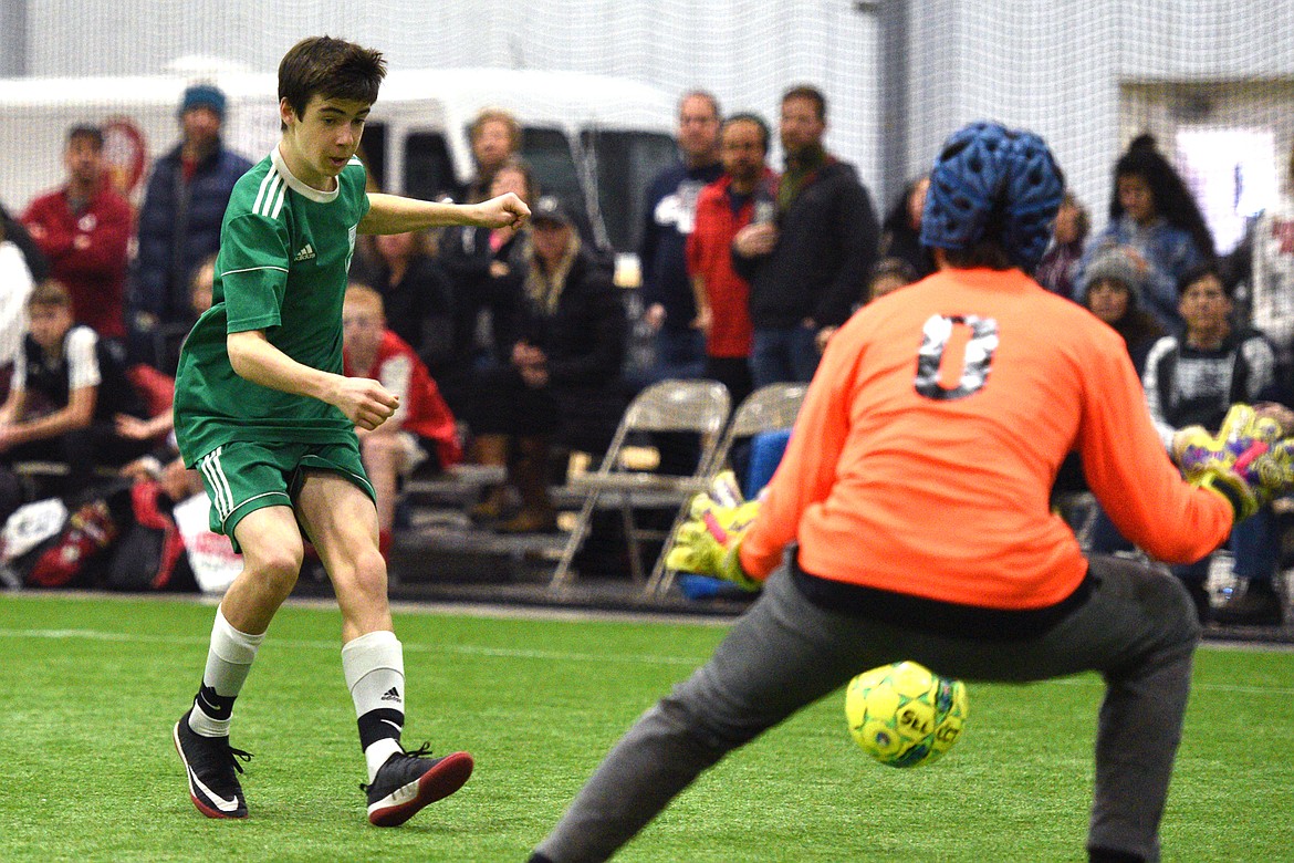 Flathead Force 03's Zane Elliott scores a goal against the Sandpoint Strikers during the Montana Indoor Soccer Championships at the Flathead County Fairgrounds on Saturday. (Casey Kreider/Daily Inter Lake)