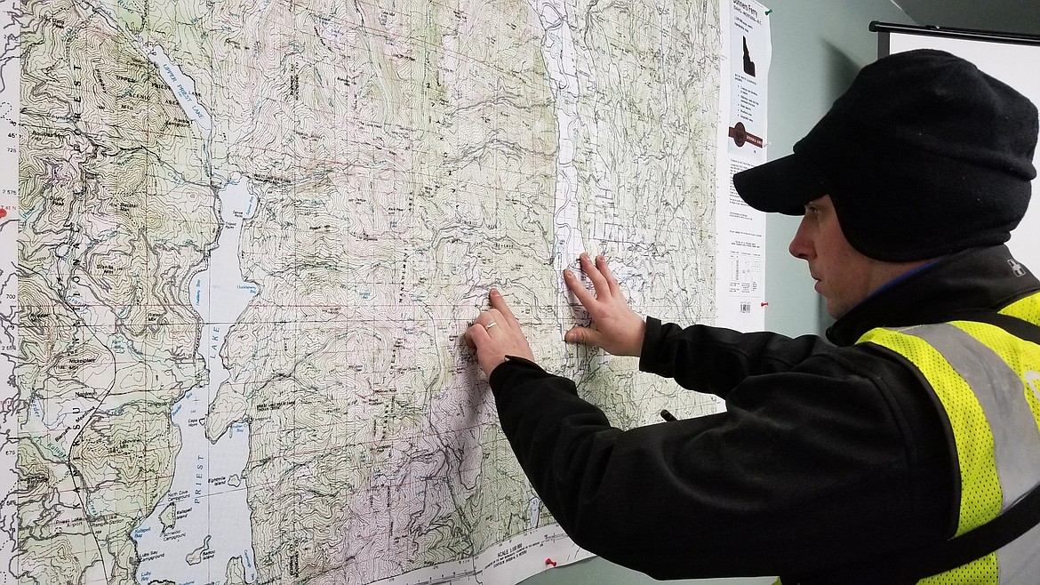 Photo by Mandi Bateman
Boundary Search and Dive Rescue Team Vice Commander Tony Jeppesen at SAR Command, identifying possible locations of the missing snowmobiler.