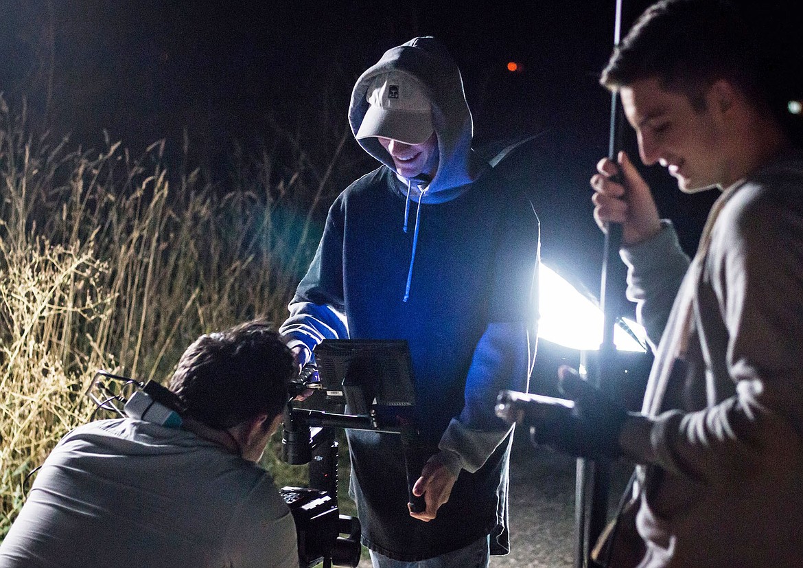 Photo by TRISHA BRAUN
Coeur d&#146;Alene filmmaker Caden Butera, left, reviews footage while working on his next film, &#147;E Equals,&#148; with Keanu Melton, center, and brother Rylan Butera. Caden will present a 20-minute concept version of the film at Hayden Cinema 6 at 5:30 p.m. on Friday, March 9 during an interactive premiere event. Tickets are $10 each and available at www.eequals.website. Sales will help Caden&#146;s capital campaign to fund a feature-length film that will use local talent and be shot in the Inland Northwest.