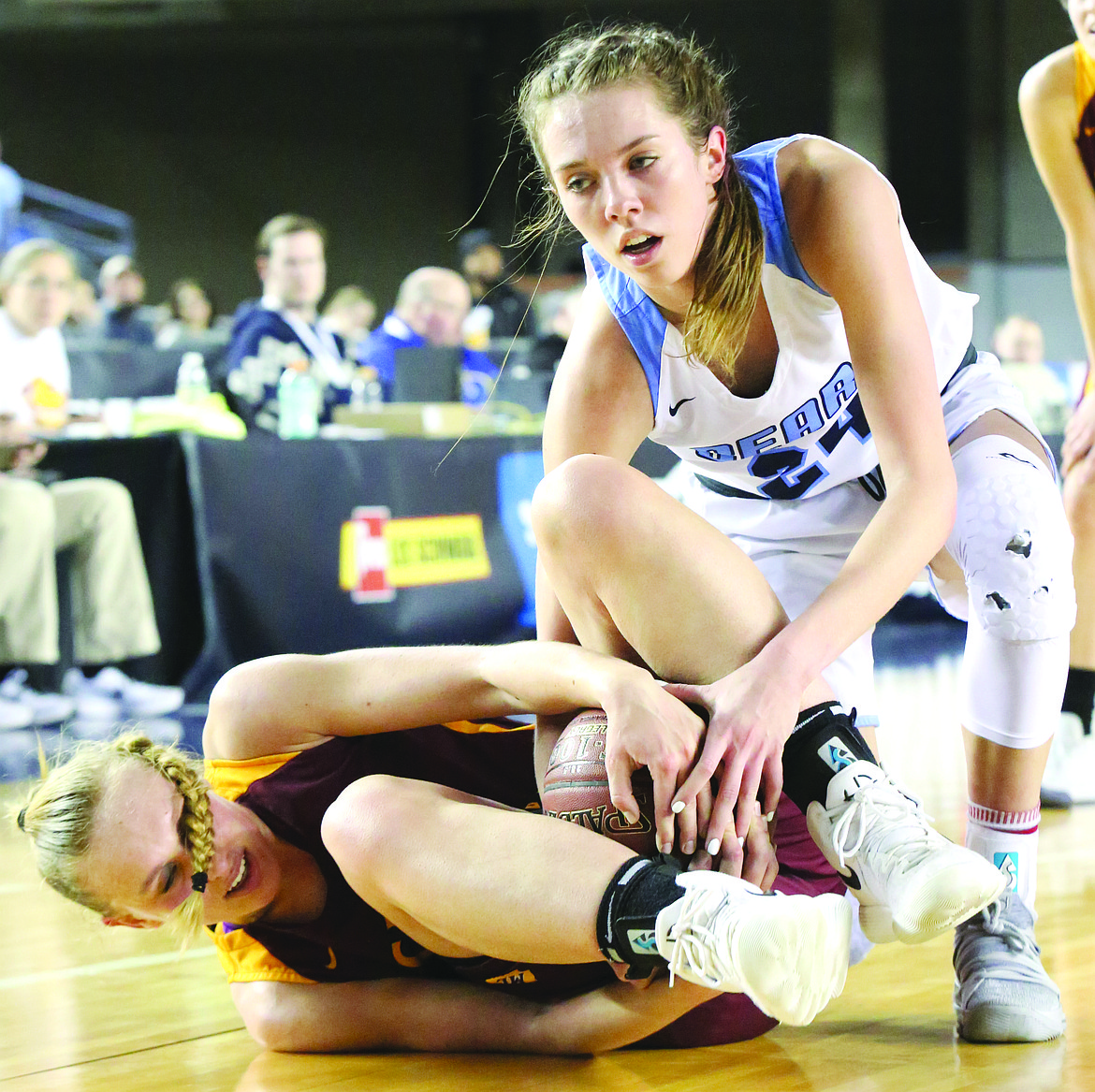 Connor Vanderweyst/Columbia Basin Herald
Moses Lake's Abby Rathbun (maroon) gets tied up with Central Valley's Lacie Hull during the state semifinals.