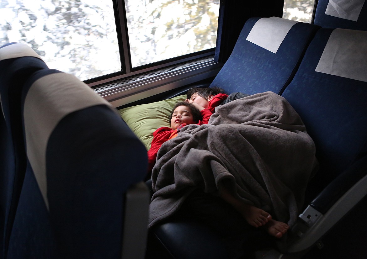 Young passengers sleep through the early morning hours on an Amtrak train headed east after making a stop in Whitefish. (Mackenzie Reiss/Daily Inter Lake)