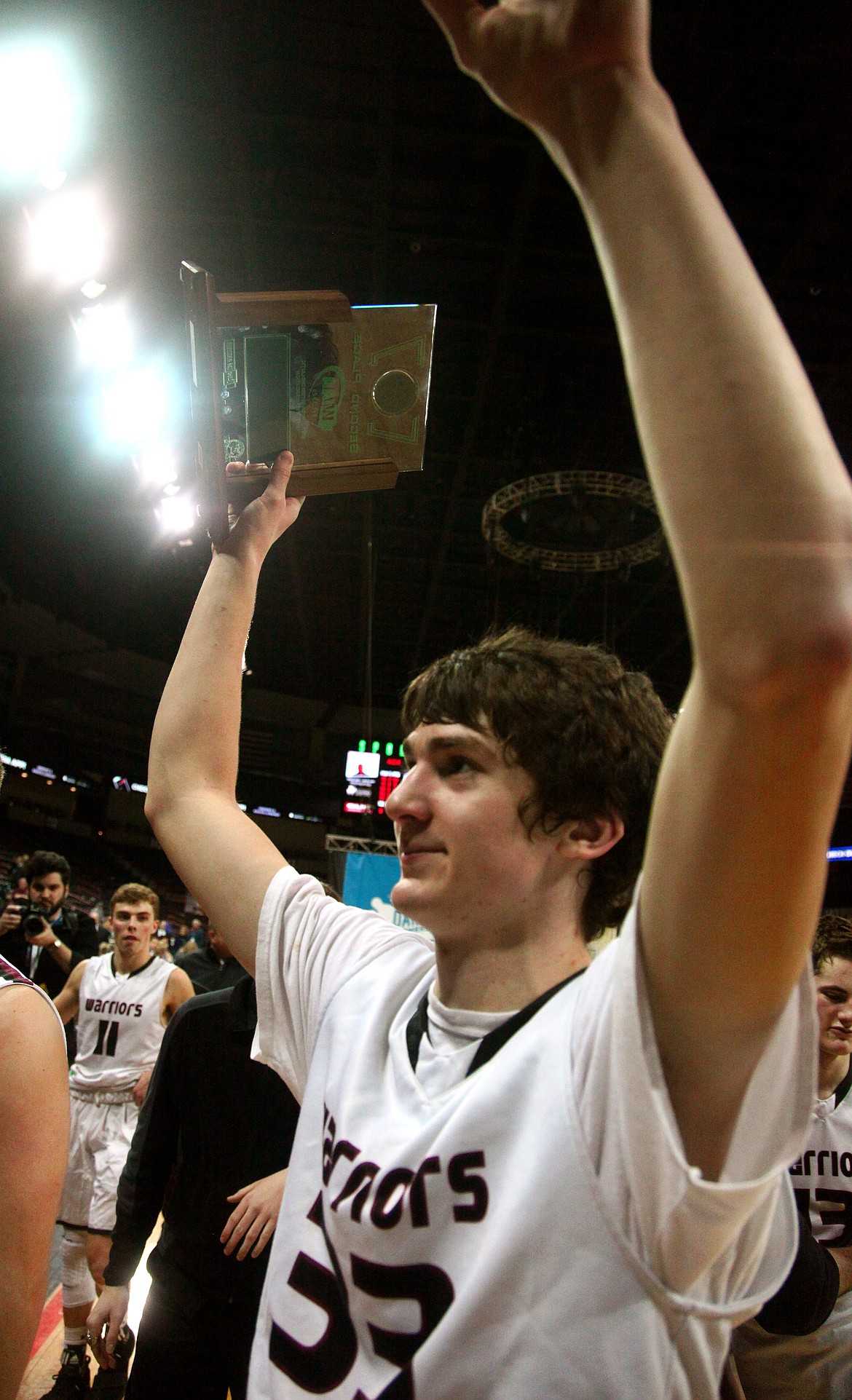 Rodney Harwood/Columbia Basin Herald
Almira/Coulee-Hartline senior Payton Nielsen raises the 1B Hardwood Classic runner-up trophy in acknowledgement to the Warriors fanbase, following Saturday night's state championship game at the Spokane Arena.