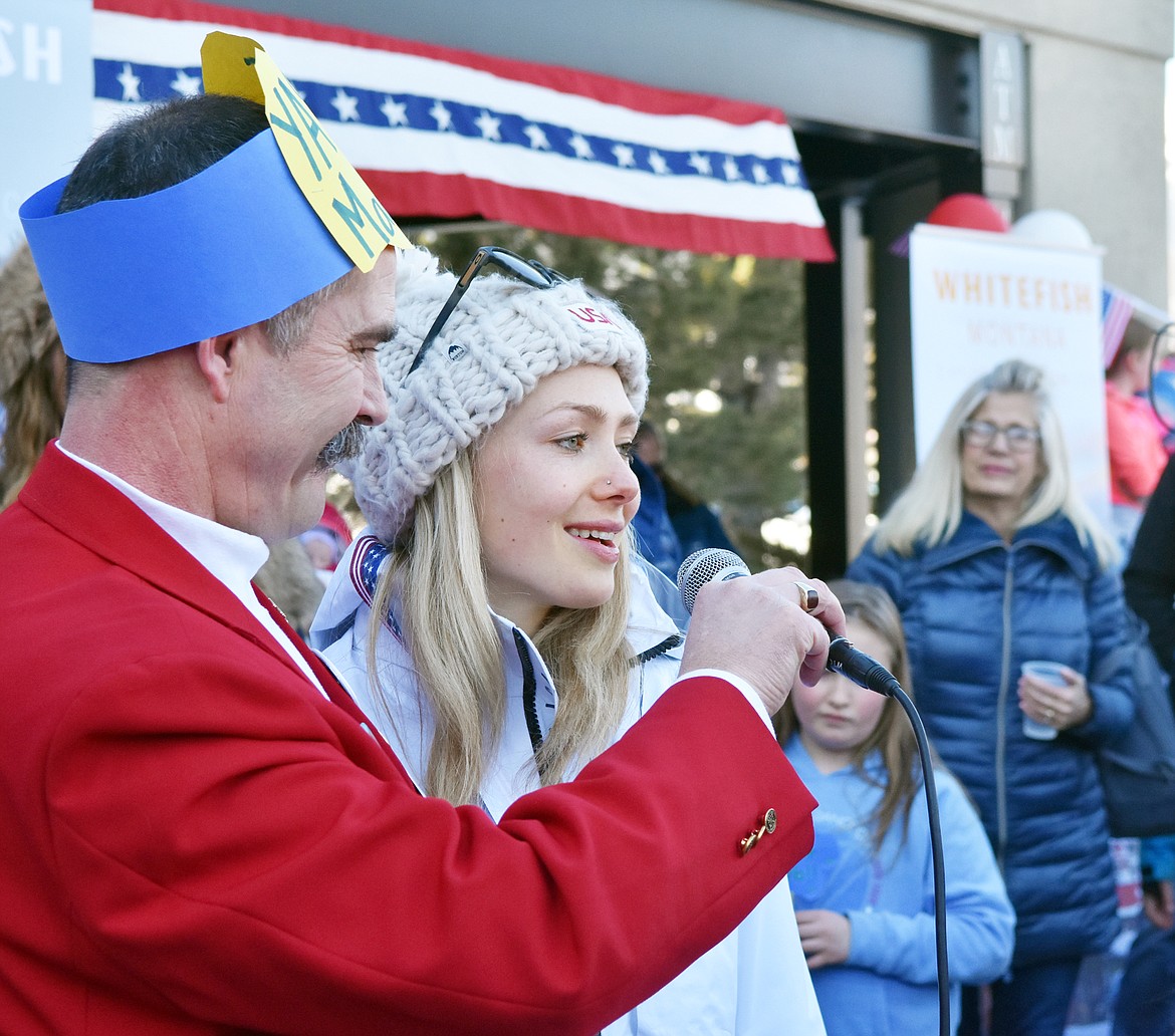 Whitefish Olympian Maggie Voisin thanks Whitefish for its support while speaking into a microphone held by her uncle Jeff Raper during a celebration ceremony Wednesday afternoon downtown. (Heidi Desch/Whitefish Pilot)