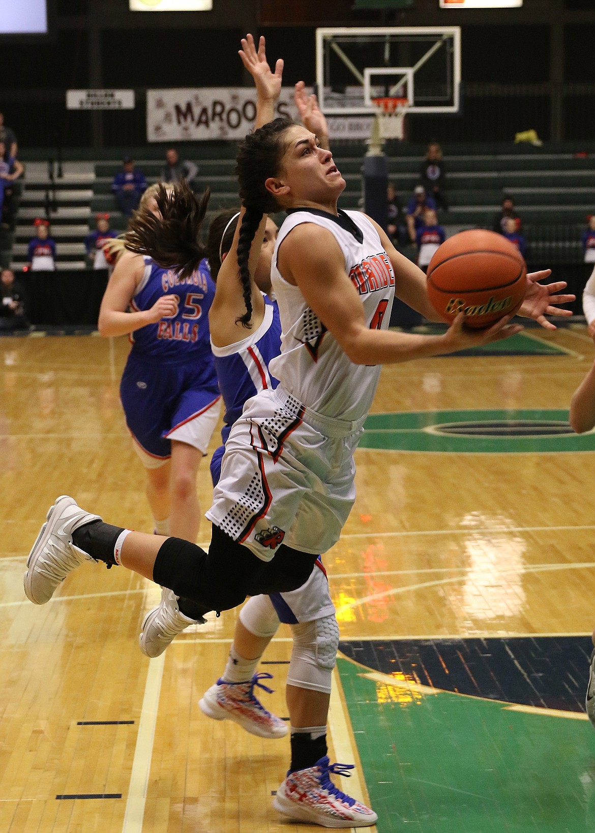 RONAN GUARD Micalann McCrea drives to the basket in the Divisional Tournament against Columbia Falls at the Butte Civic Center. McCrea was selected to play in the Mission Valley All-Star basketball game. (photo courtesy of Bob Gunderson)