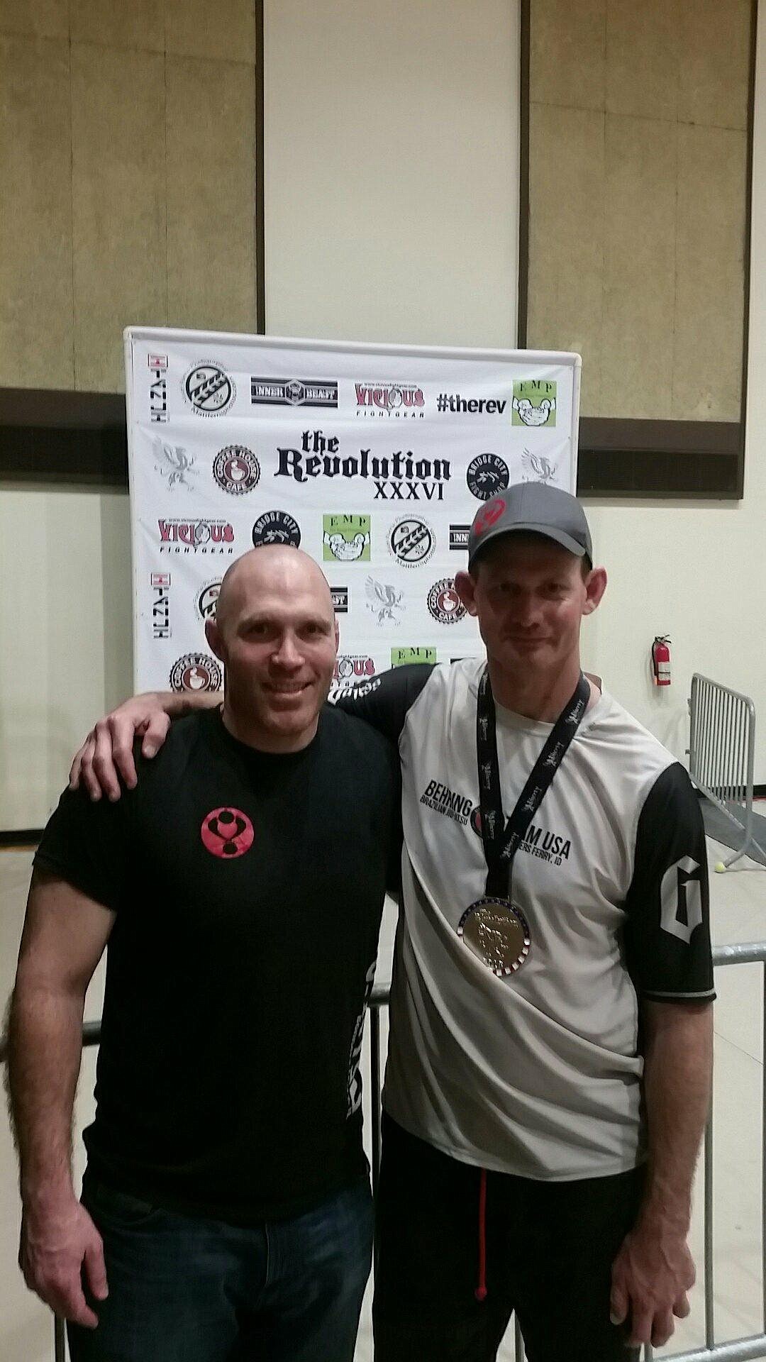 Coach Sam Brown stood proudly next to Eric Bender, who placed first in gi.