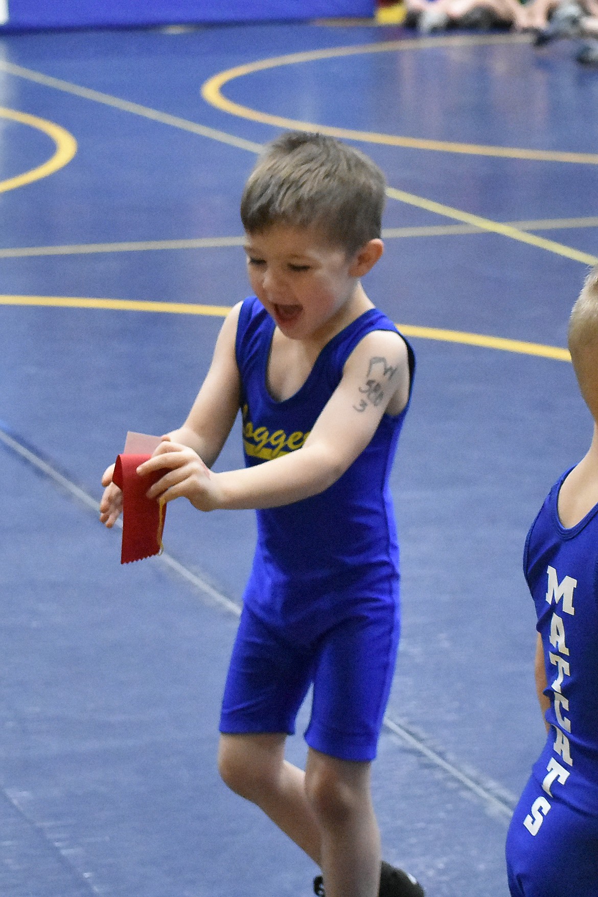 Charles Arnold II walks away with his ribbon after a Pee Wee match during the Kootenai Klassic, March 3. (Ben Kibbey photos/The Western News)