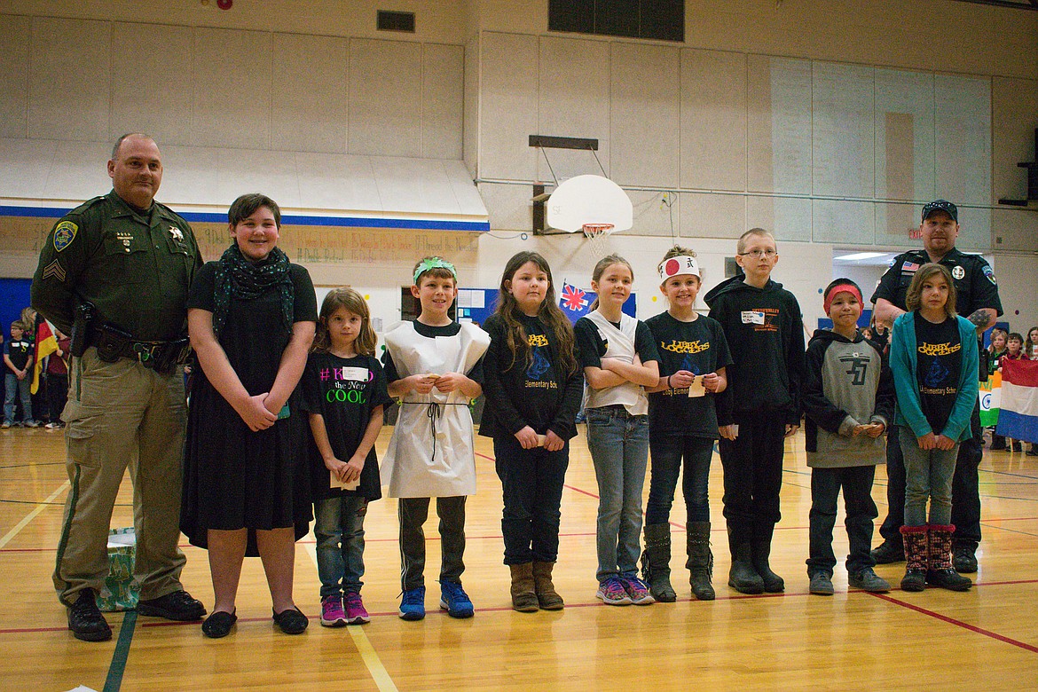 Montana Highway Patrol Sergeant Neil Duram and Libby Police Officer Chris Pape congratulated some of the winners and participants in the Lincoln County DUI Task Force's safe driving essay contest, at Libby Elementary School, March 2. Pictured: Duram, Libby Middle School winner Taryn Thompson, Ali Clemmons, Zane Dodson, Arial Bush, Leah Rusdal, Libby Elementary winner Emily Harmon, Tanner Wolfe, Kayden No Runner Lyllian Johnson and Pape. (Ben Kibbey/The Western News)