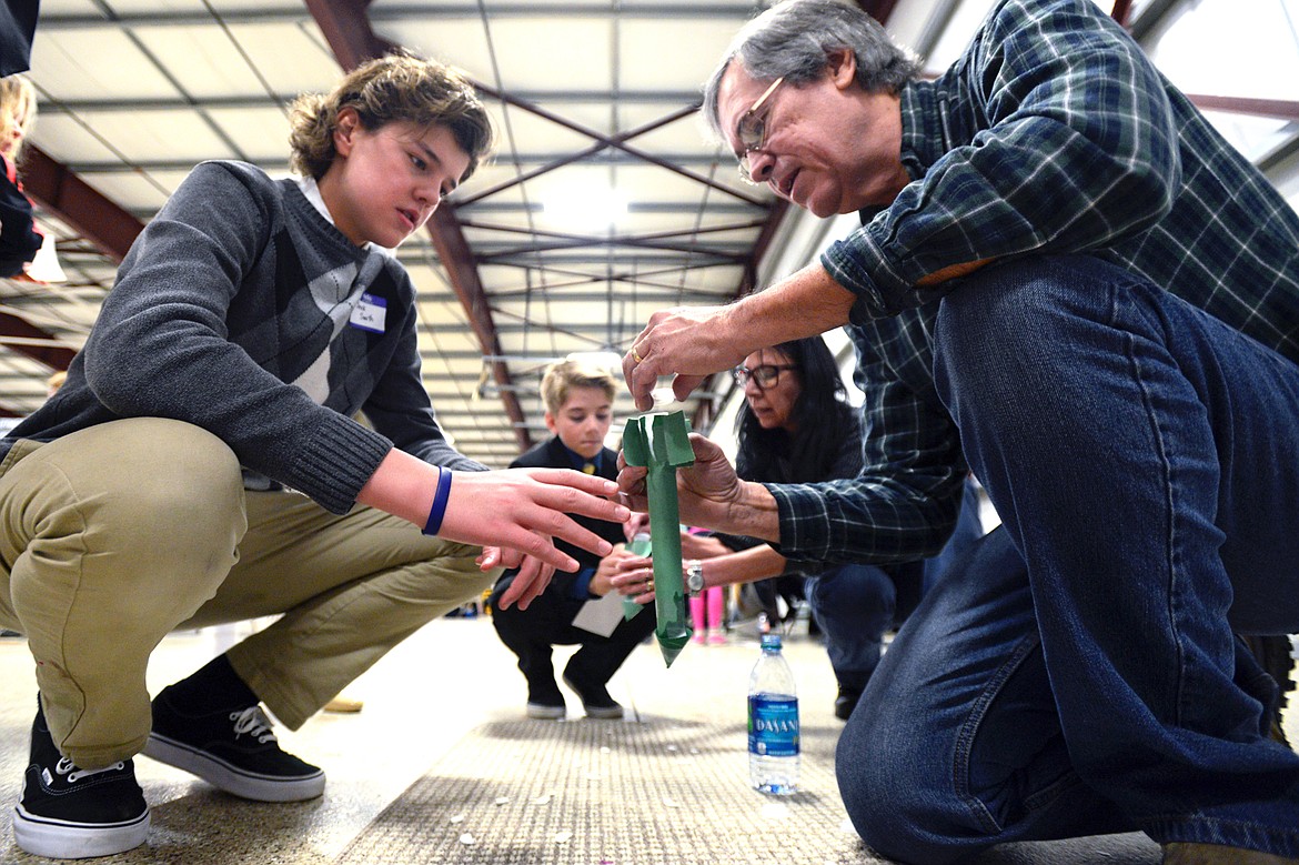From left, Derek Smith, an eighth-grader at St. Matthew&#146;s Catholic School, Andrei Young, a fifth-grader at Bigfork Elementary, and volunteers Alison Godfrey and Steve Alejandro prepare rockets powered by Alka-Seltzer tablets and water at the Flathead County Science Fair on Thursday. (Casey Kreider/Daily Inter Lake)