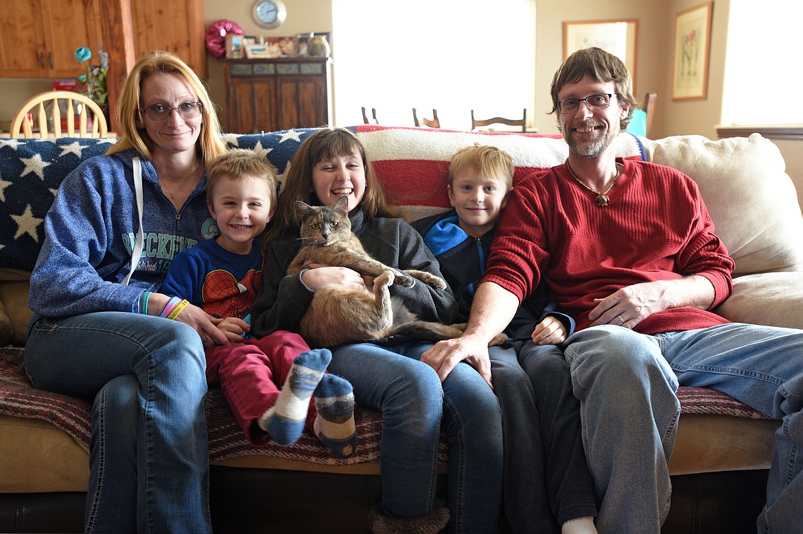 The Coyle family, from left, Elizabeth, Riley, Shannon with cat Honey, Quincy and Luke at their home on Friday, Feb. 23. (Casey Kreider/Daily Inter Lake)