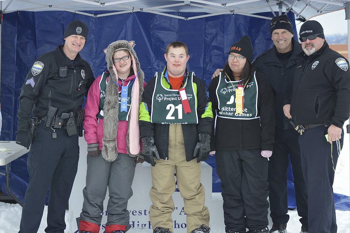 PICTURED LEFT to right are Polson Police Sgt. George Simpson, Mercedes Dunkerson of Polson High School, Dothan Steve of Polson High School, Rakeena Caye of Ronan High School, Polson Police Detective Rick Schoening, and Polson Police Chief Wade Nash. The group attended Polson High School for a snowshoe event. (Photo courtesy of Rose Gurul&eacute;)