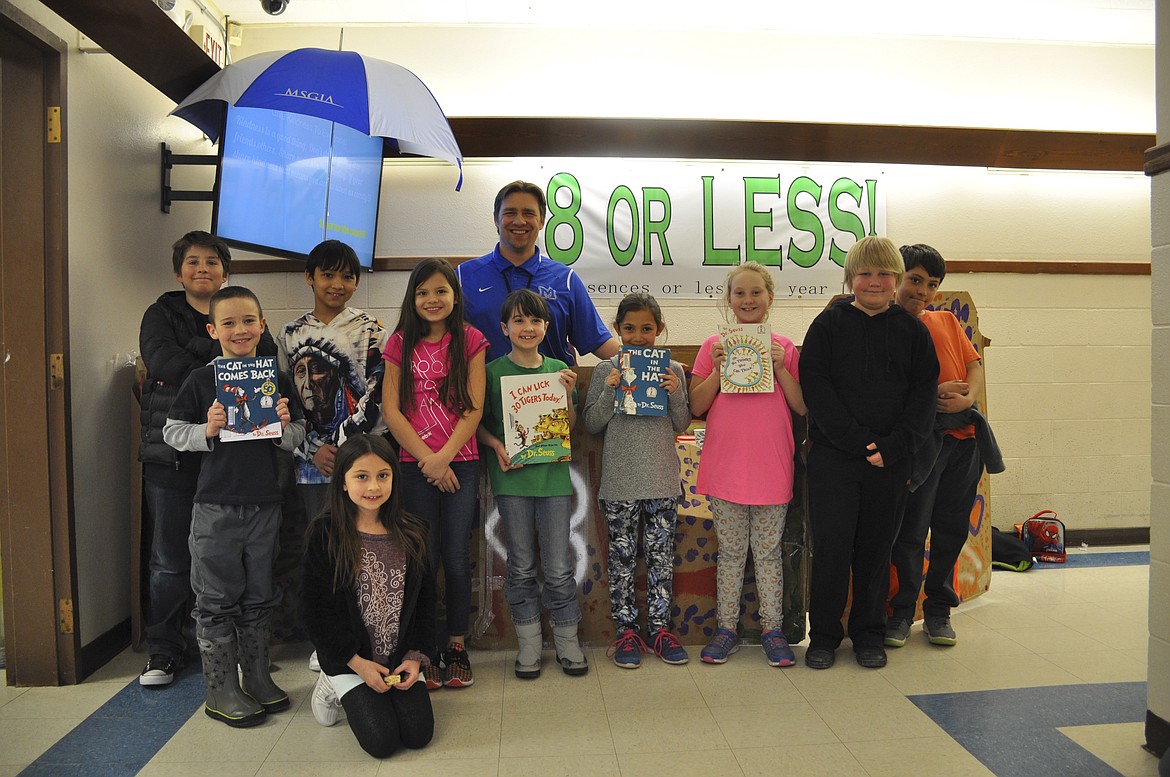 STUDENTS FROM St. Ignatius Elementary School pose with their principal, Tyler Arlint, who spent March 1 in a box after the school read 1,856 books in February. (Ashley Fox/Lake County Leader)