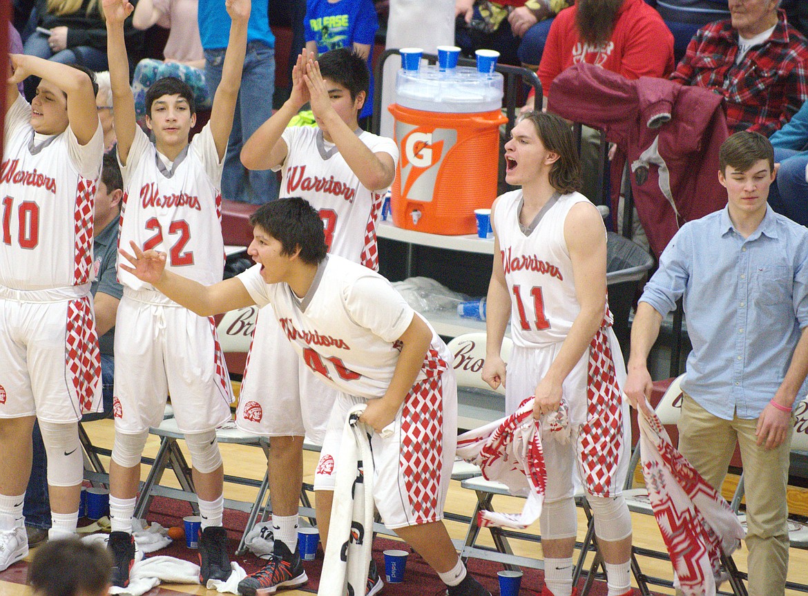 THE ARLEE Warriors bench celebrates during their big first half against Plains (from left): Cody Tanner, David Haynes, Billy Fisher, Trey Malatare and Nathaniel Coulson all celebrate during the MHSA Class championship victory over Plains Saturday night at Hamilton High School. (Jason Blasco/Lake County Leader)