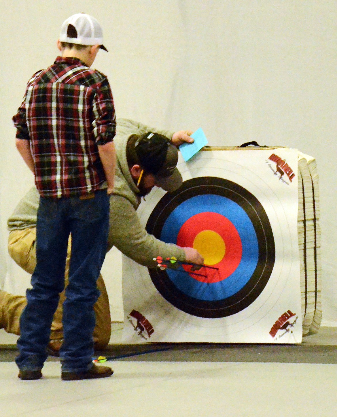 Scorer Matthew Faroni checks Justin Perry&#146;s shots on the bullseye after his third round shot on the 10-meter line. (Erin Jusseaume/ Clark Fork Valley Press)