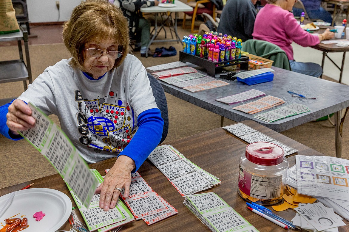 Nancy Gab sorts bingo cards at the Libby Senior Center on Saturday, March 3, 2018. (John Blodgett/The Western News)