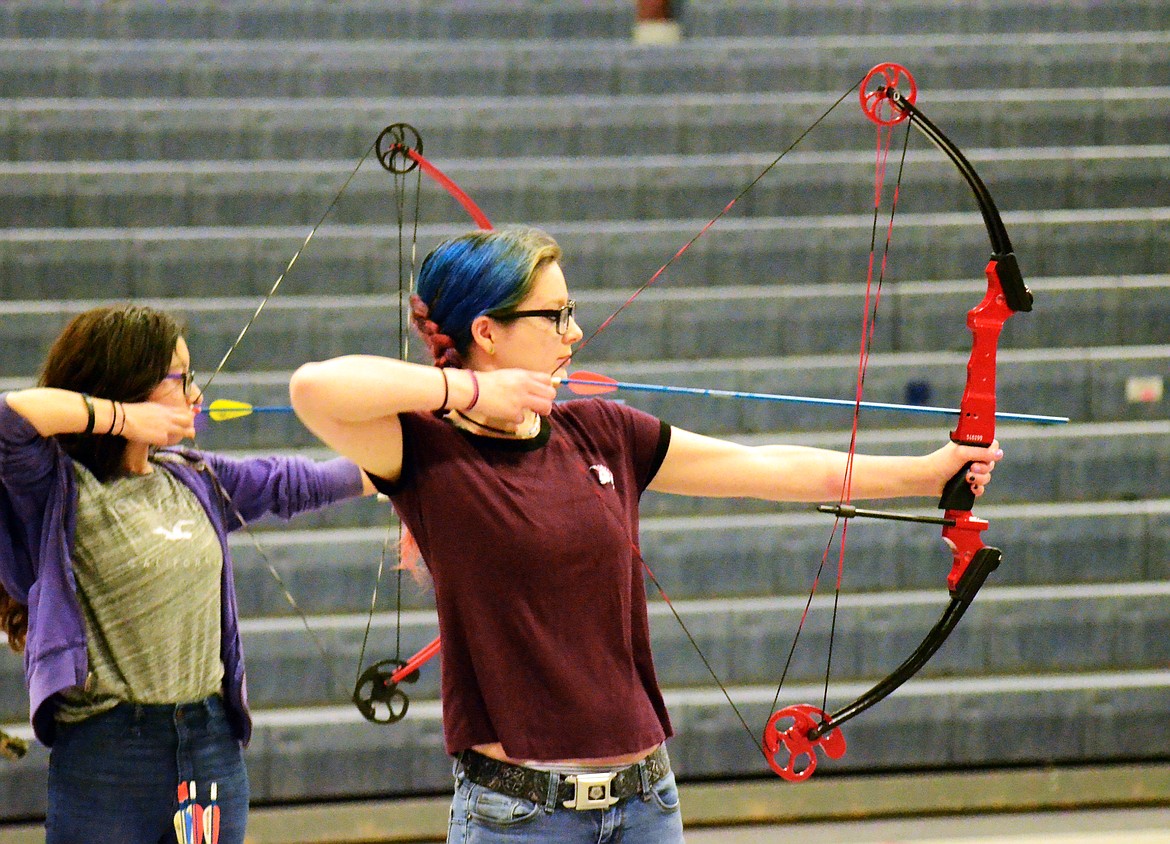 High school students Ruby Martinez and Ilanna Chaney take aim at their targets during the National Archery in the Schools Program over the weekend. (Erin Jusseaume/ Clark Fork Valley Press)