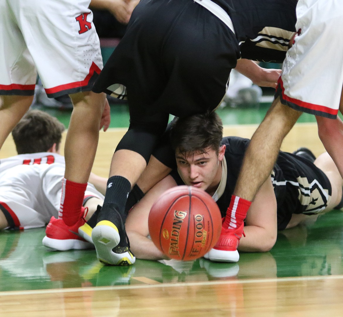 Bob Kirkpatrick/The Sun Tribune - Isaac Ellis scrambles for a loose ball in the game against King&#146;s Saturday.