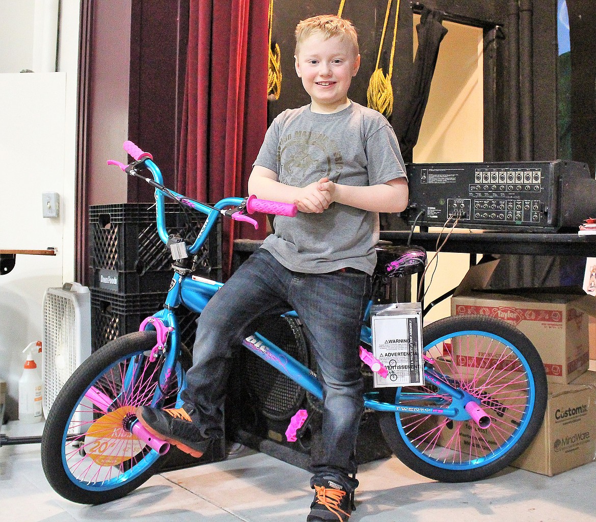 Evan Fehlings sits on a bike he won in a drawing during Alberton&#146;s &#147;I Love to Read Month.&#148; It was donated by the Masons in Superior. (Photo by Rochelle Knapp)