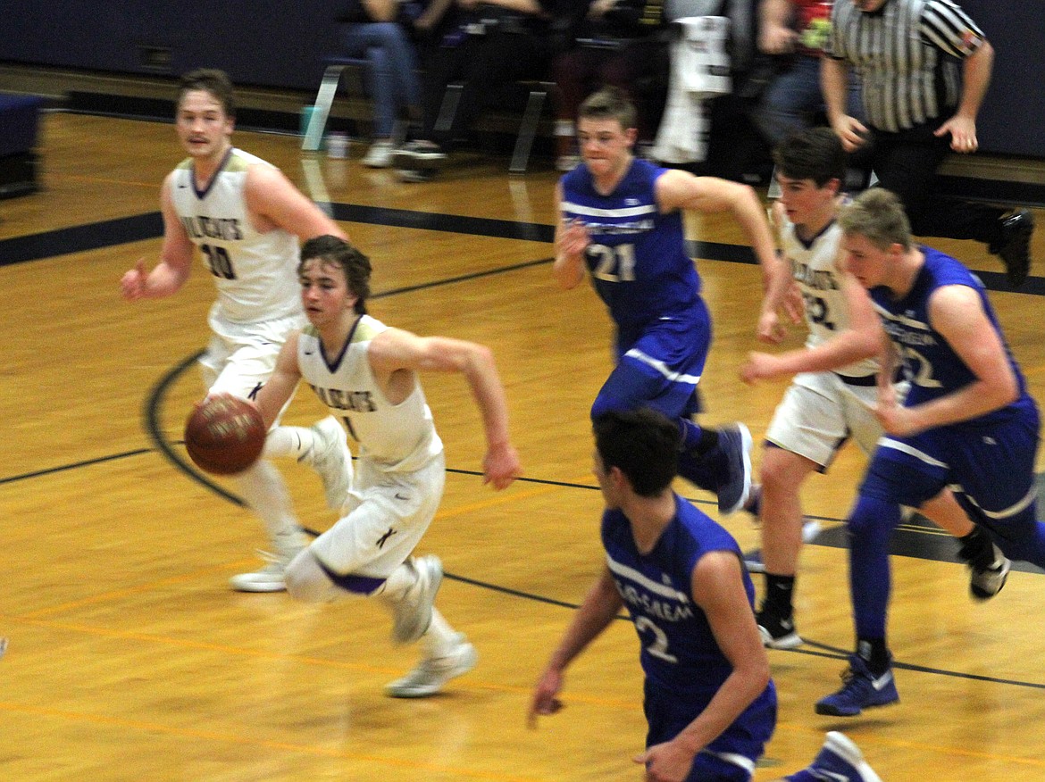 Tyler Gibbons pushes the ball in transition for the Wildcats.