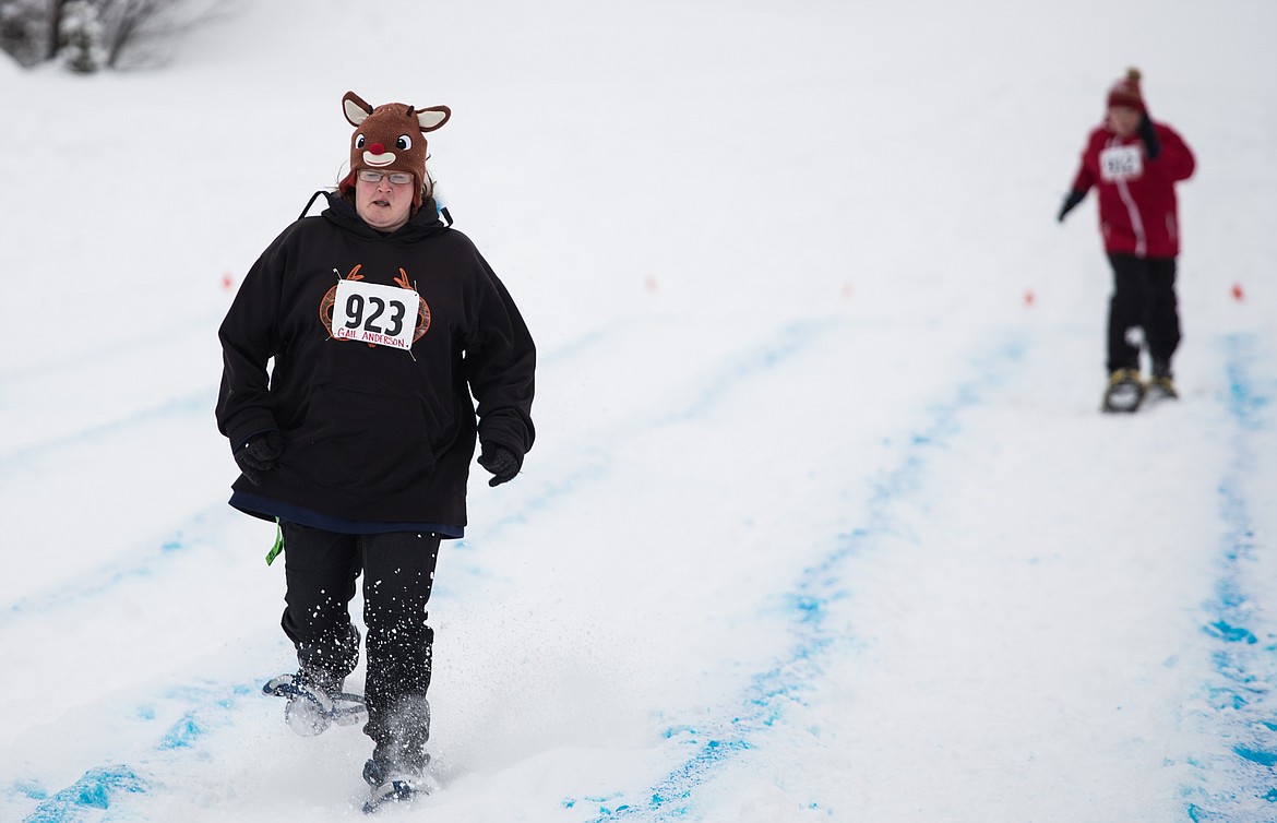 Gail Anderson of the Kalispell Krushers streaks ahead to the finish of the snowshoe race Monday at the resort.