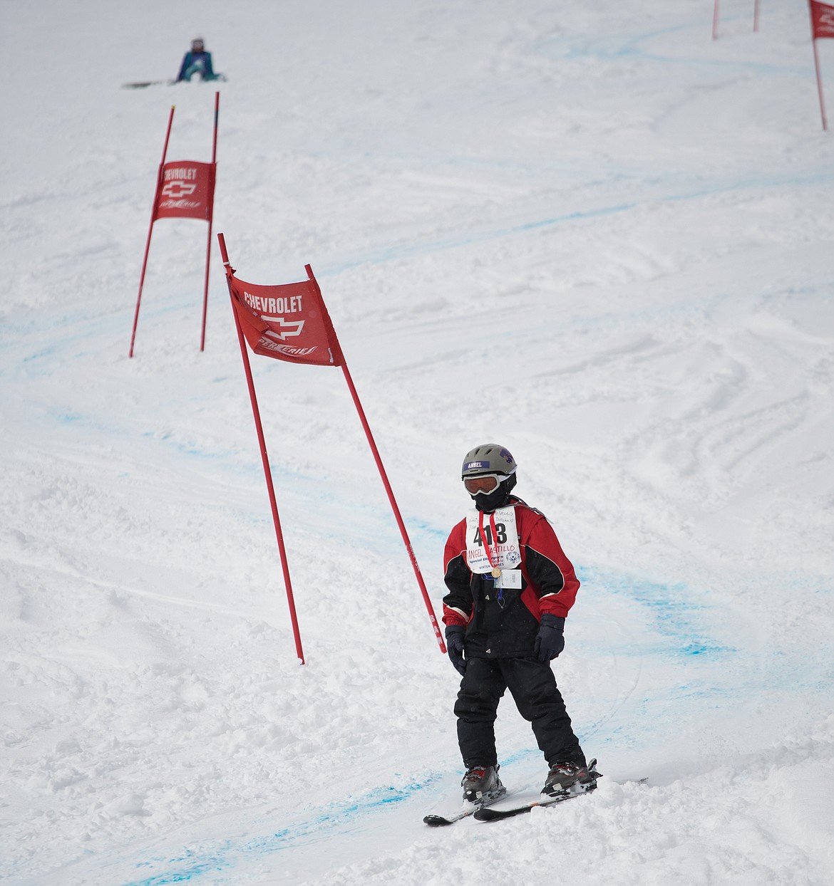 Angel Castillo of Columbia Falls wears a medal from a previous event as he finishes the slalom at the 2018 Special Olympics Montana Winter Games at Whitefish Mountain Resort.