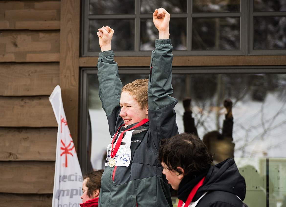 Kyro Rogers of Kalispell celebrates his gold medal on the podium at the 2018 Special Olympics Montana Winter Games at Whitefish Mountain Resort.