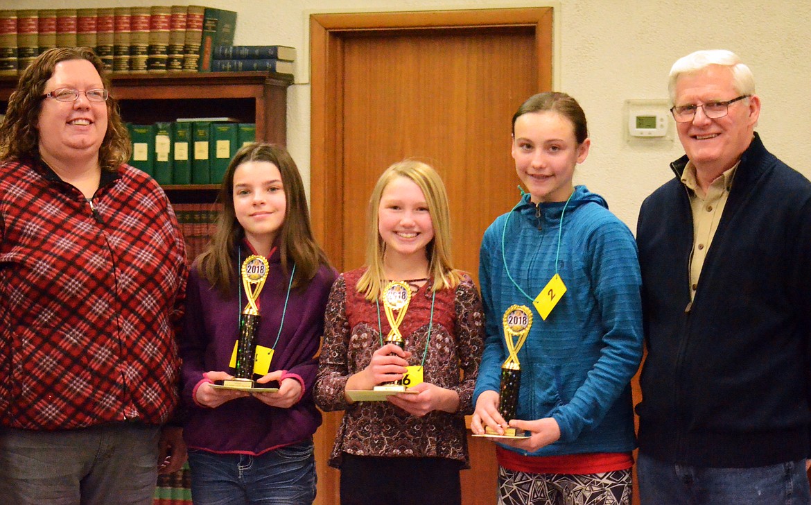 Spelling Bee Champs are all smiles after the tough competition. L-R Annie Woodenrepresenting the Sanders COunty Ledger a major sponsor for the event, Kaitlyn Ducept of PLains first place winnner, Piper Bergstrom of Plains thrid place winner, Hattie Neesvig of Thompson Falls second place winner, Pronouncer Dan Whittenburg. (Erin Jusseaume/ Clark Fork Valley Press)