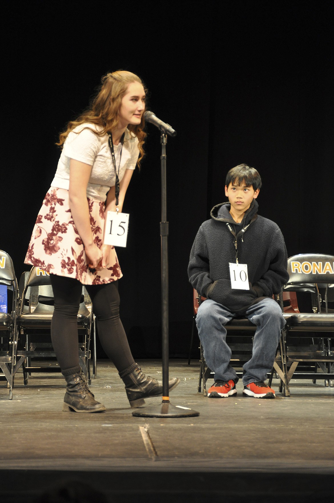 MOLLYKATE SULLIVAN, an eight-grade student at the Charlo School District, takes her turn spelling a word during the 53rd Lake County Spelling Bee as John Paca, an eigth grader at Ronan, watches. (Ashley Fox/Lake County Leader)