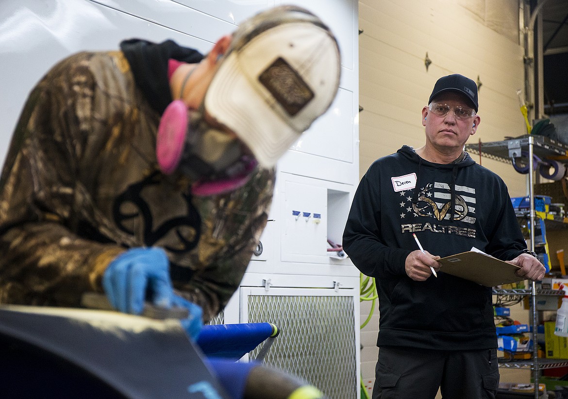 LOREN BENOIT/Press
Coachman Body Shop employee and volunteer judge Deren Guerrero, right, critiques Jordan Blood&#146;s dent repair Friday morning at North Idaho College Parker Technical Education Center&#146;s Friendly Skills USA Scrimmage.