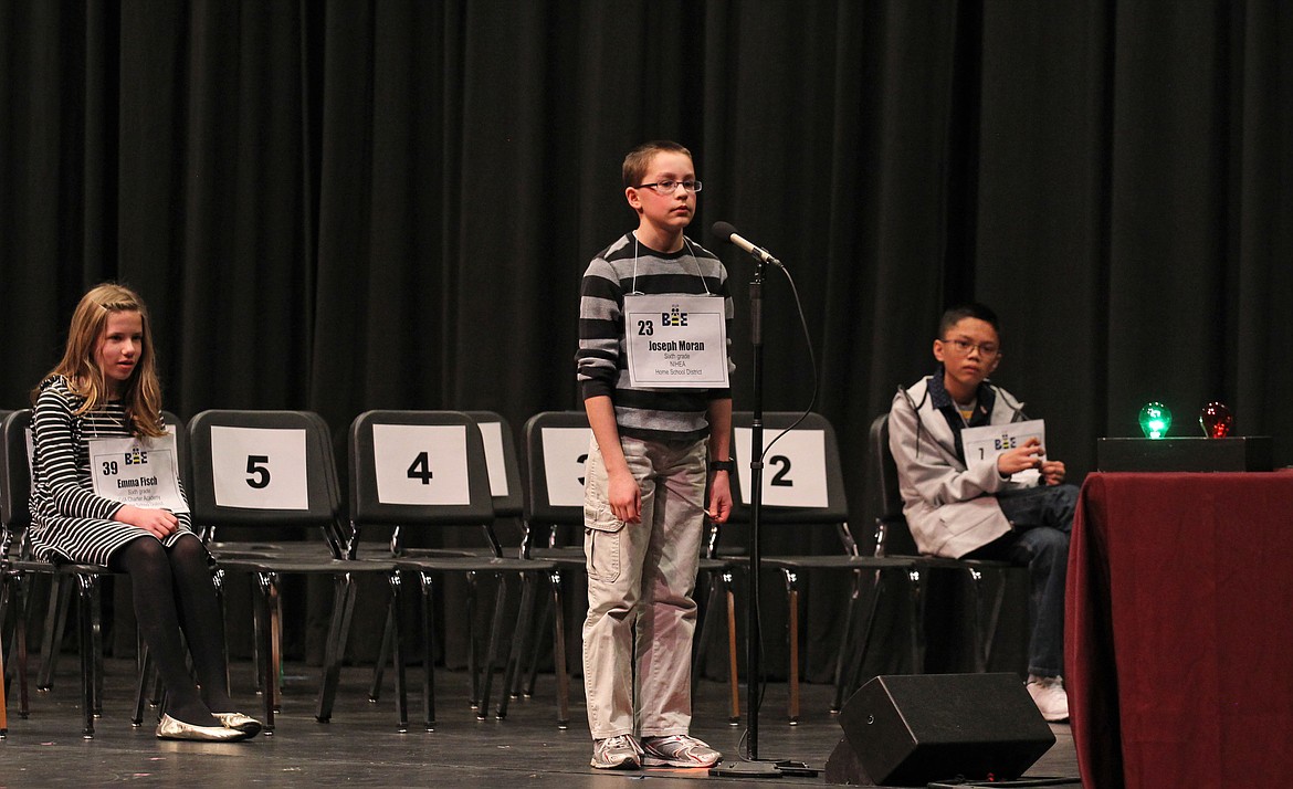 All eyes are on the green light Saturday morning during the 15th annual North Idaho Regional Spelling Bee at North Idaho College. The bee lasted a near-record 26 rounds, including several rounds where these three students all spelled their words correctly. Coeur d'Alene Charter Academy sixth-grader Emma Fisch, left, made it 12 rounds. Joseph Moran, a homeschooled sixth-grader, center, was defending champion and once again will represent North Idaho in the Scripps National Spelling Bee in Washington, D.C. in May. Sandpoint Middle School seventh-grader and first runner-up Urielle Abad, right, gave Joseph a run for his money when it was just the two of them battling it out for 14 rounds. (DEVIN WEEKS/Press)