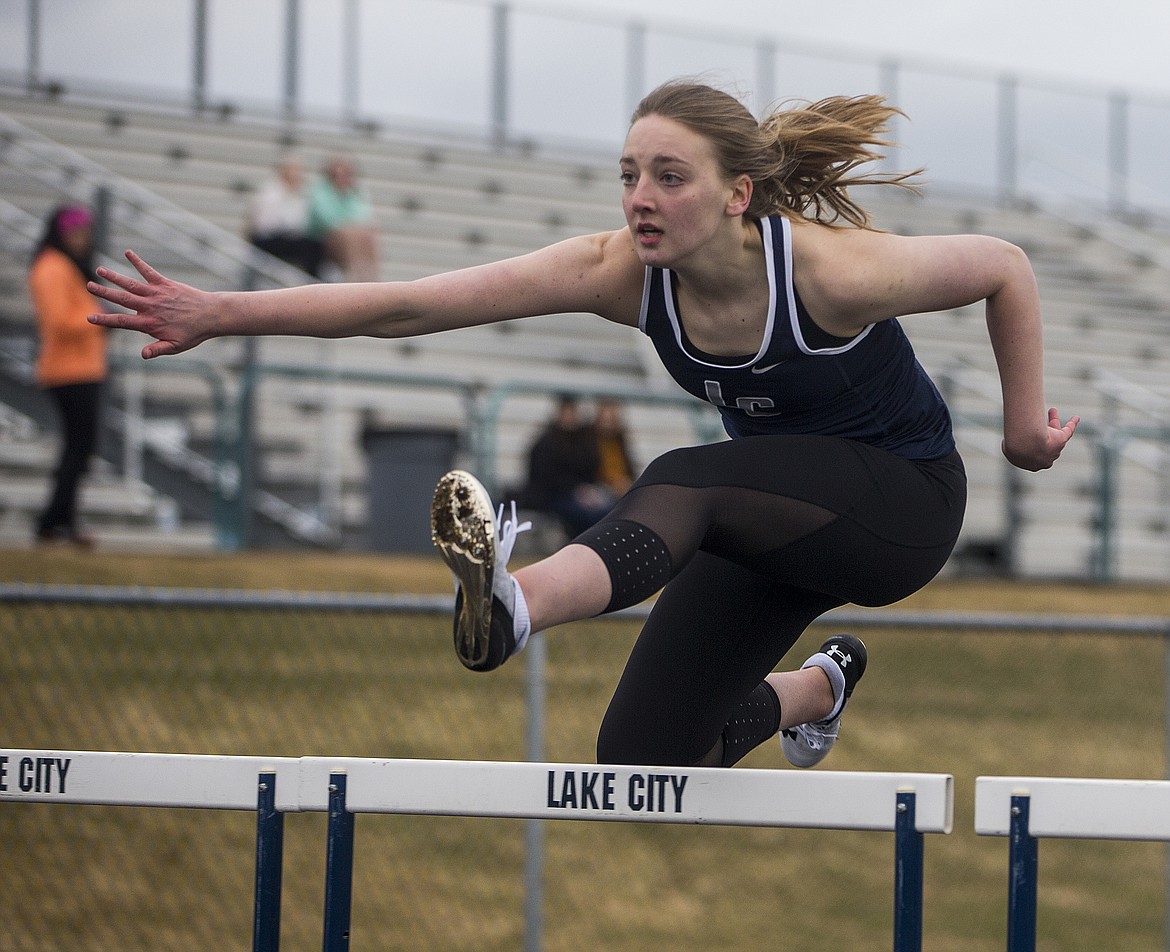 Kinsey Freeman of Lake City High jumps over a hurdle Thursday afternoon at the Battle of the Baton track meet between Lake City and Post Falls High Schools. (LOREN BENOIT/Press)