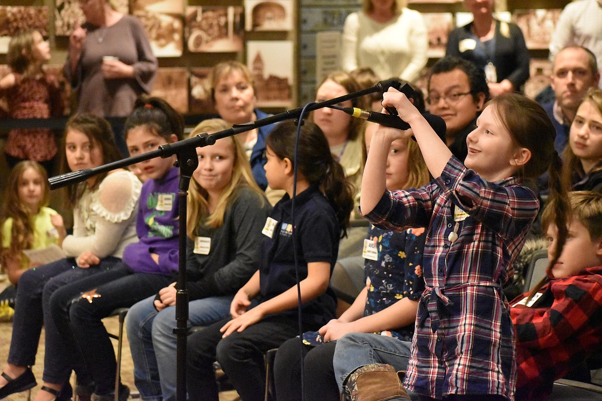 Northwest Expedition Academy third-grader Cadence Brumbaugh adjusts the microphone during the school's spelling bee earlier this year before she went on to compete in the district bee in January. The North Idaho Regional Spelling Bee starts at 9 a.m. Saturday in the Schuler Performing Arts Center on the North Idaho College Campus, where about 40 fifth-through-eighth-graders will compete for an all-expense-paid trip to Washington, D.C. to participate in the Scripps National Spelling Bee at the end of May. (Courtesy photo)