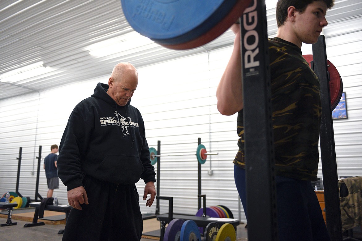 Mike Gerber, owner of Montana Sport-Strength, spots Henry Nuce, a sophomore at Glacier High School, as he works out on Tuesday, Feb. 20. (Casey Kreider/Daily Inter Lake)