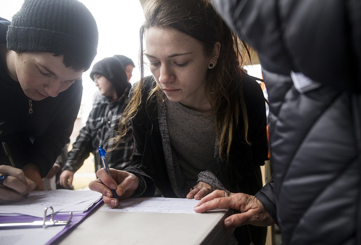 Lake City High School student Violet Barber registers to vote during National School Walkout, a nation-wide protest against gun violence, on Wednesday. (LOREN BENOIT/Press)