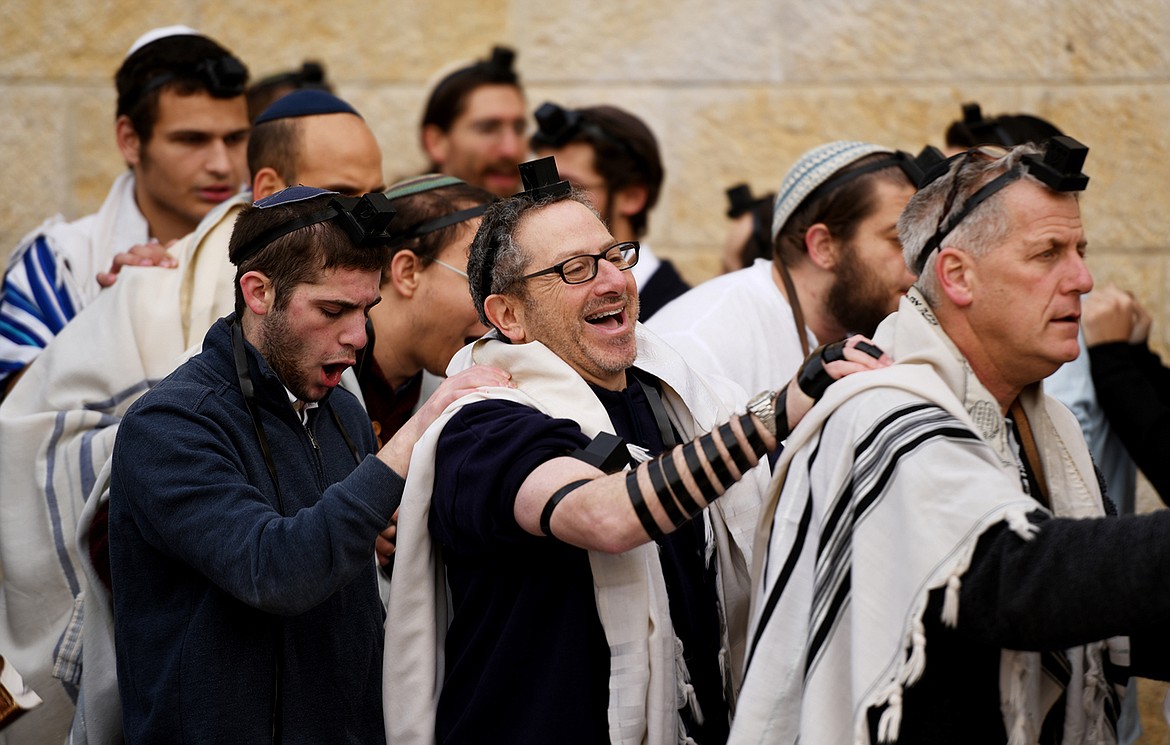 Men gather to dance and sing at Rosh Hodesh at sunrise at the Western Wall on February 16, in Jerusalem. Rosh Hodesh is a minor Jewish holiday celebrating the new month based on the lunar calendar.(Brenda Ahearn/Daily Inter Lake)