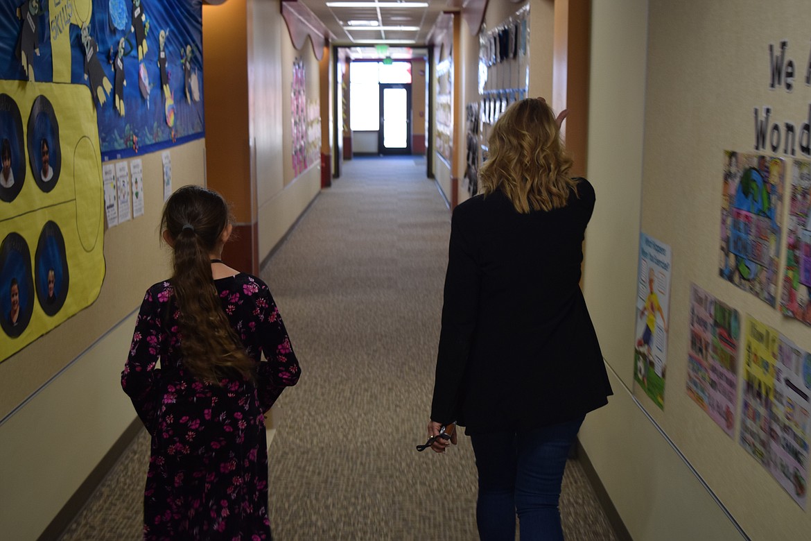 Charles H. Featherstone/Columbia Basin Herald
Third-grader Vanessa Kumar Suglani and Principal Noreen Thomas walk the halls of Sage Point Elementary School on Friday morning to make sure all the doors are closed.