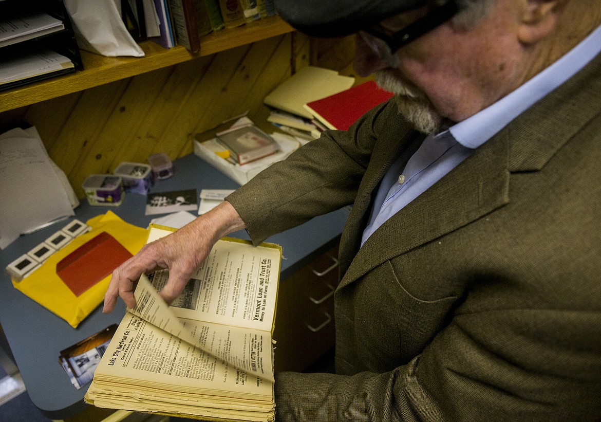Historian Robert Singletary flips through a 1912 directory book in storage at Museum of North Idaho last Thursday. (LOREN BENOIT/Press)