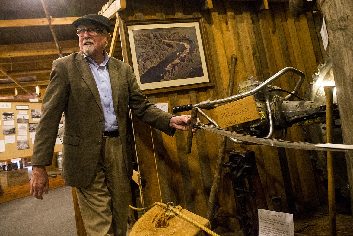 Robert Singletary, with the Museum of North Idaho, shows off a cross cut saw that was used in the area in the late 1940s and into the early 1950s. (LOREN BENOIT/Press)