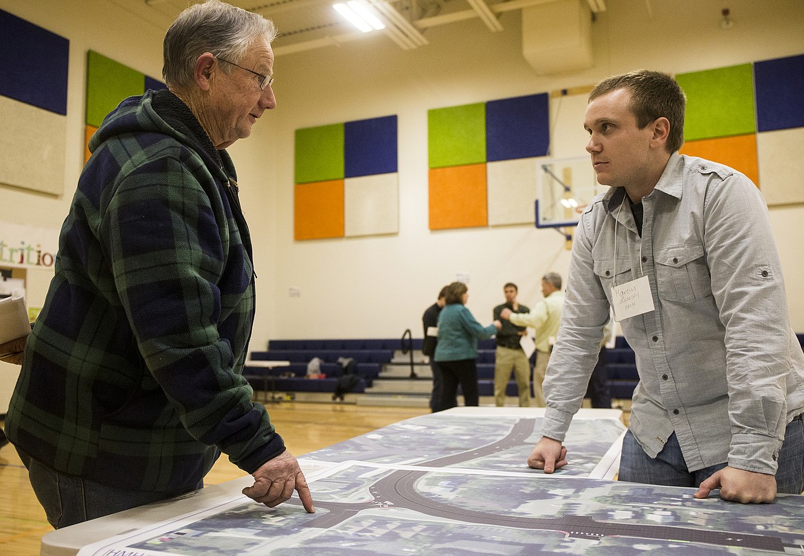 Joseph Culbreth speaks about his property concerns with HMH engineer Marcus Levesey during a hearing Monday night for improvements to the 3-way stop at U.S. 95, Lincoln Way and Walnut Avenue. (LOREN BENOIT/Press)