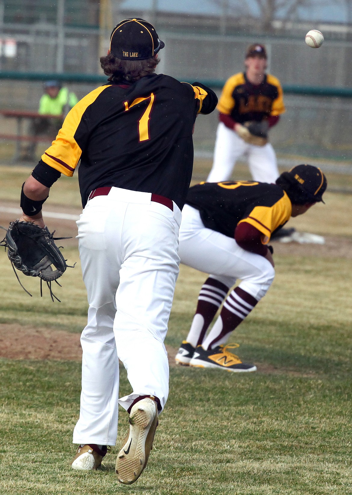 Rodney Harwood/Columbia Basin Herald
Moses Lake third baseman Dominic Signorelli (7) makes the play on a bunt over the top of a ducking Vance Alvarado to first baseman Dax Lindgren during Friday's season opener at Larson Playfield.