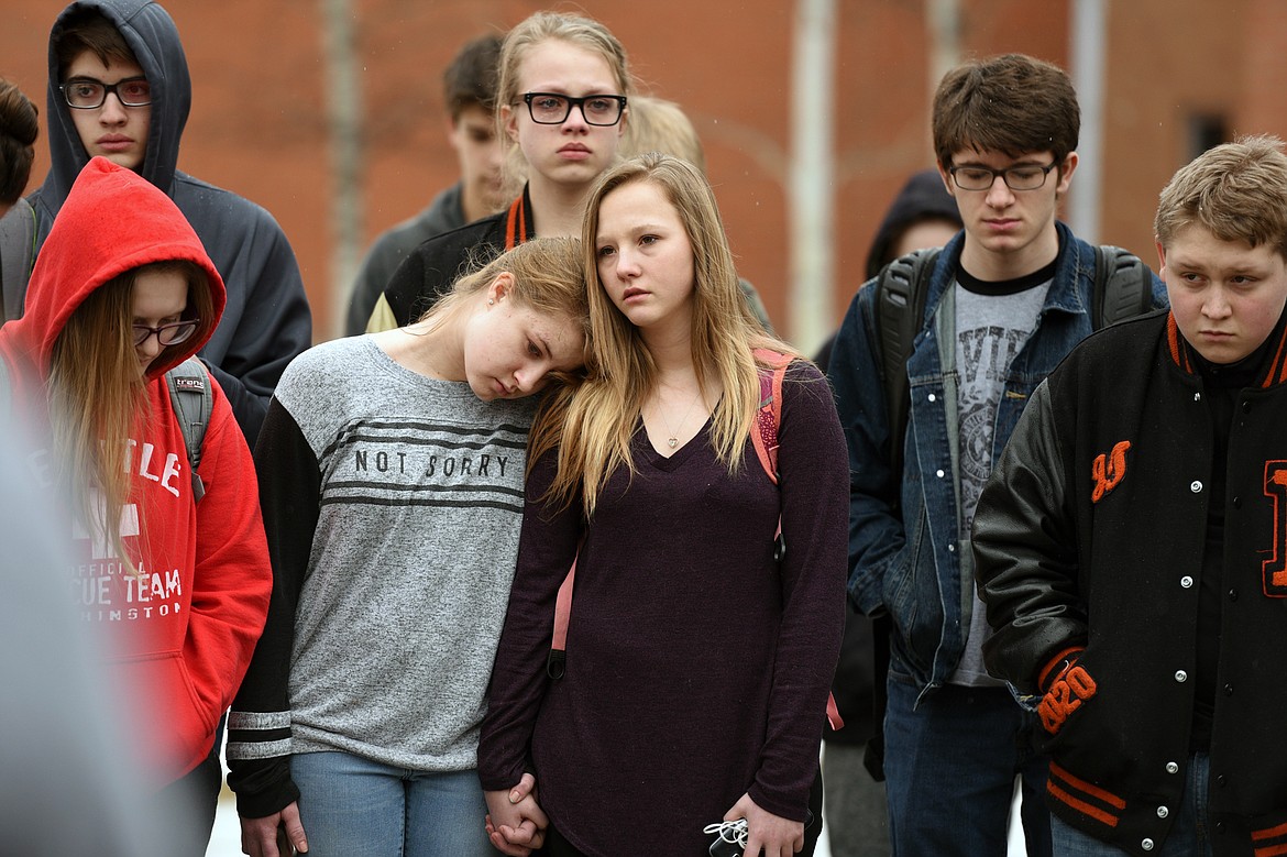 Flathead High School students participate in the student-planned &quot;17 Minutes of Silence Memorial&quot; Wednesday afternoon to mark one month since a mass shooting left 17 dead at Marjory Stoneman Douglas High School in Parkland, Fla. (Casey Kreider/Daily Inter Lake)