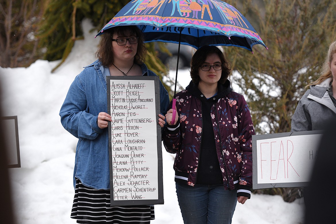 Flathead High School students participate in the student-planned &quot;17 Minutes of Silence Memorial&quot; Wednesday afternoon to mark one month since a mass shooting left 17 dead at Marjory Stoneman Douglas High School in Parkland, Fla. (Casey Kreider/Daily Inter Lake)